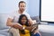 Man and woman interracial couple looking picture at home