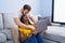 Man and woman interracial couple using laptop at home