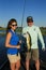 Man and Woman Large Mouth Bass Fishing in Boat