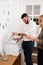 Man and woman laughing over a photo copier