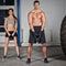 Man and woman lifting kettle bell crossfit