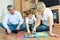 Man, woman and little boy reading book