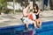 Man and Woman Lounging Beside a Pool - Horizontal