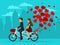 Man and woman in love riding a tandem bike with balloons as hearts