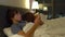 Man and woman lying in bed each with smartphone and tablet pc. woman turns off the lamp and and goes to sleep while man