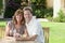 Man & Woman Married Couple Sitting In Garden