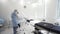 Man and woman medical doctors in the procedure room. Action. Nurse and the surgeon preparing surgical instruments and