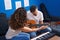 Man and woman musicians having classical guitar lesson at music studio