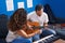 Man and woman musicians having classical guitar lesson at music studio
