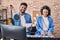 Man and woman musicians singing song playing piano at music studio