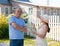 Man and woman near gate of home