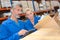 Man and woman opening box in warehouse