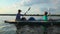 Man and woman paddle boat synchronously, teamwork, togetherness