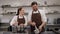 A man and a woman pastry chefs prepare a dessert together in a pastry kitchen.