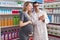 Man and woman pharmacist and pregnant client holding pills bottle speaking at pharmacy