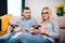 Man and woman playing video games. man is angry and girl is winning. Details of modern lifestyle and free time concept