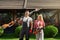 Man and woman posing at garden with electric hedge trimmers