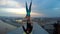 Man and woman practicing acrobatic yoga on top of bridge, dangerous sports