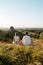 Man and Woman Practicing Yoga and Meditation Outdoors at Sunset with Scenic Landscape and Nature Miracle Giant Stone on