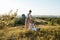 Man and Woman Practicing Yoga Outdoors at Sunset with Scenic Landscape and Nature Miracle Giant Stone on the Background