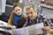 Man and woman in printing house checking print quality