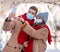 Man and woman in protective masks taking selfie on smartphone