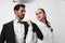 Man and woman pulling on tie anger business looking at each other screaming with hands up in white isolated background