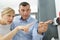 Man and woman push finger down on fingerprint machine