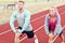 Man and woman racing on outdoor track