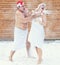 Man and woman refresh in snow after hot sauna.Concept of: relax, vacation,healthy lifestyle.