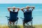 Man and woman relax and unwind in camping chairs