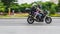 Man and woman riding on bmw f800r motorcycle. Young couple riding motorbike on city road