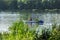 Man and woman rowing oars in the canoe on the river