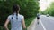 Man and woman runner running on open road in countryside