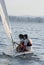 Man and Woman Sailing in Boat on Lake - Vertical