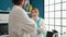 Man and woman scientists speaking with arms crossed gesture at laboratory