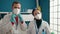 Man and woman scientists wearing medical mask at laboratory