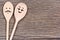 Man with woman shape of wooden spoons on table