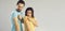 Man and woman show arms after flu or Covid-19 shots standing on gray copy space background