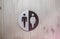 Man and woman sign for bathroom. Black and white wooden circle for the toilet