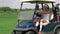 Man and woman sit in golf cart