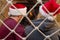 A man and a woman sit in a hammock in front of the fireplace in Christmas hats and look at the fire. Family holiday at Christmas