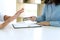 man and woman sit at the table to sign