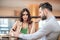 Man and woman sitting in a restaurant and looking unpleased