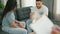 Man and woman sitting on sofa having couple therapy at psychology clinic