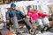 Man and woman skiers sitting in sun lounger