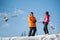 Man and woman skiers with skis at winter resort