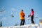 Man and woman skiers with skis at winter resort