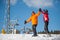 Man and woman skiers with skis at winter resort