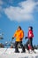 Man and woman skiers with skis at winter resort